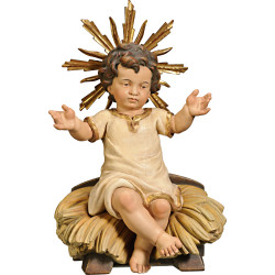 Niño Jesús vestido sentado en cuna